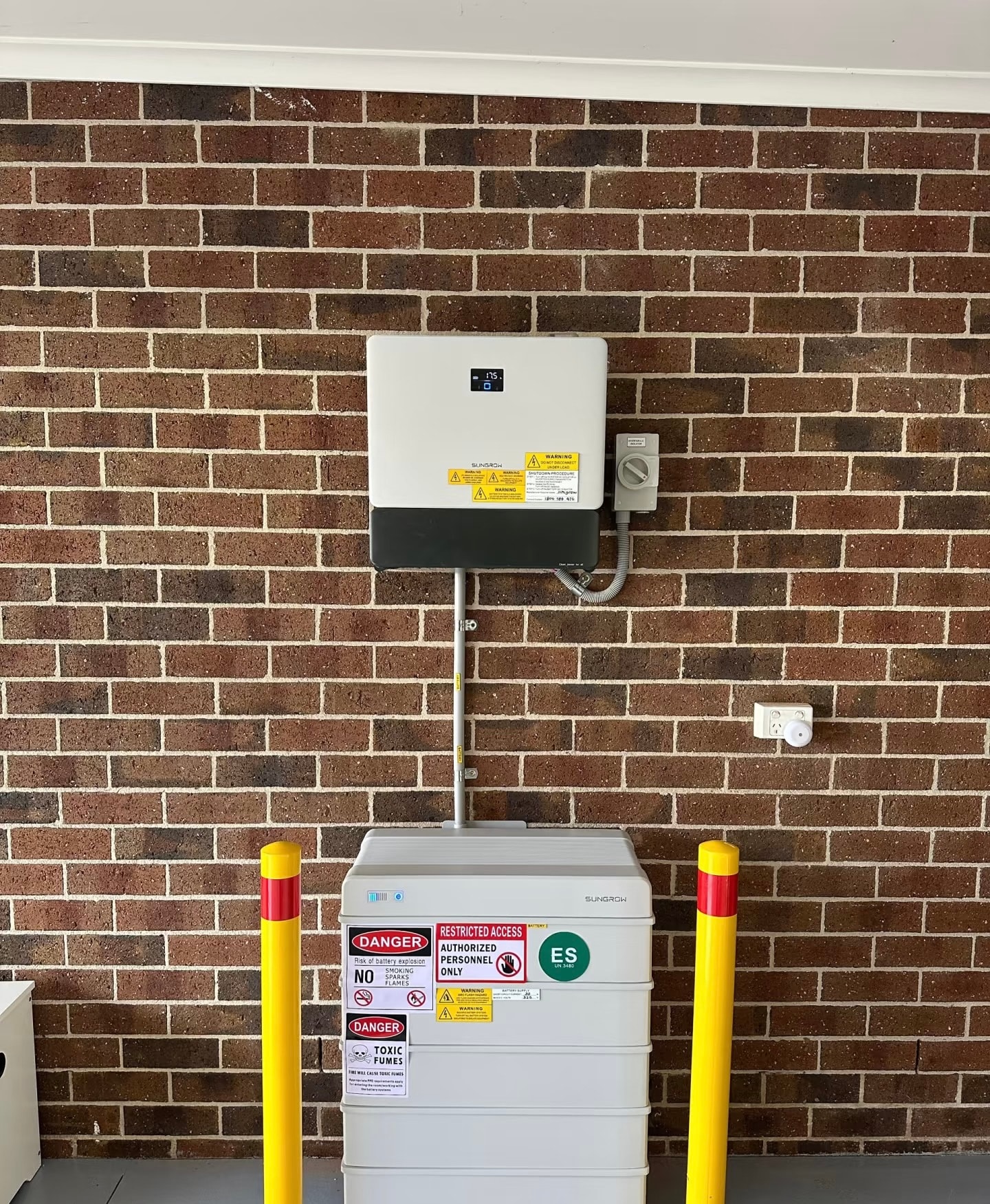 Sungrow inverter and battery on brick wall