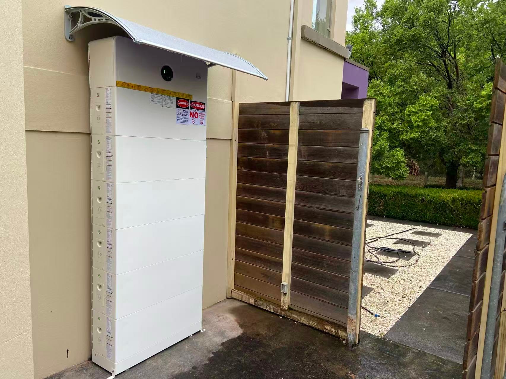 Battery storage unit beside wooden gate